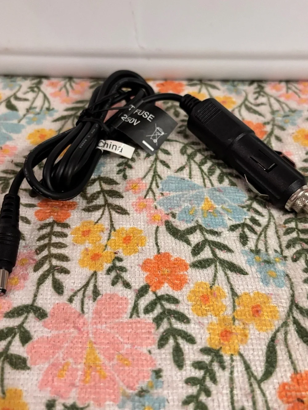 12V DC vehicle power adapter commonly used to charge portable devices